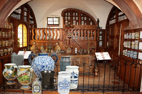 Aufstellung der Sammlung im Deutschen Apotheken-Museum, integriert in das Barock-Mobiliar aus der Hof-Apotheke Bamberg. Im Vordergrund einige besonders bemerkenswerte St&uuml;cke der Sammlung. Bild: Deutsches Apothekenmuseum